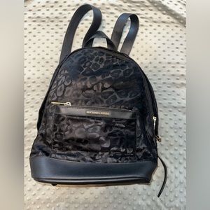 Michael Kors Kelsey backpack tote in black with gold hardware.